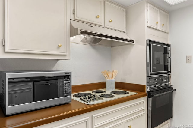 kitchen with stainless steel microwave, wall oven, white cabinets, white electric cooktop, and under cabinet range hood