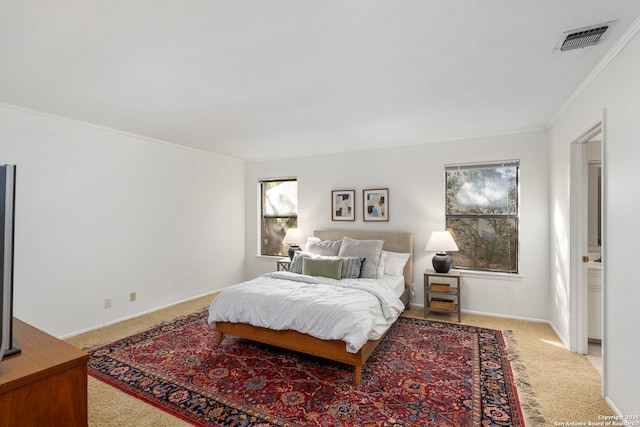 bedroom featuring multiple windows, visible vents, and light colored carpet