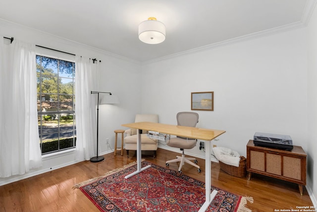 home office featuring crown molding, baseboards, and wood finished floors