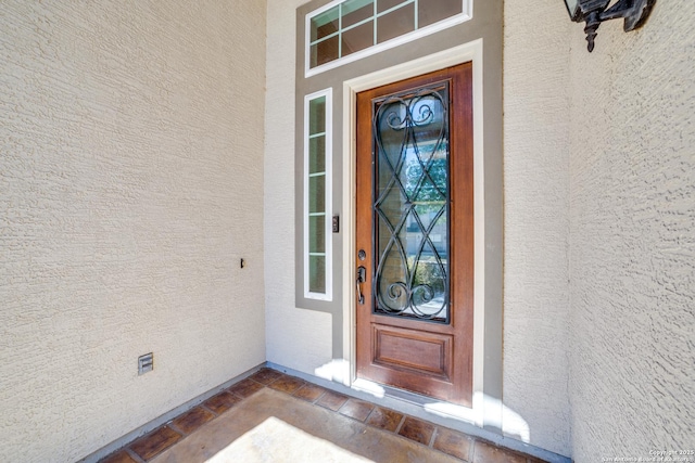 property entrance with stucco siding