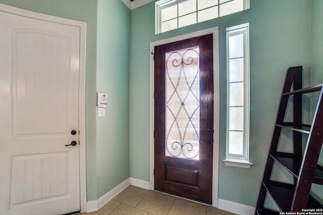 entrance foyer featuring light tile patterned floors and baseboards