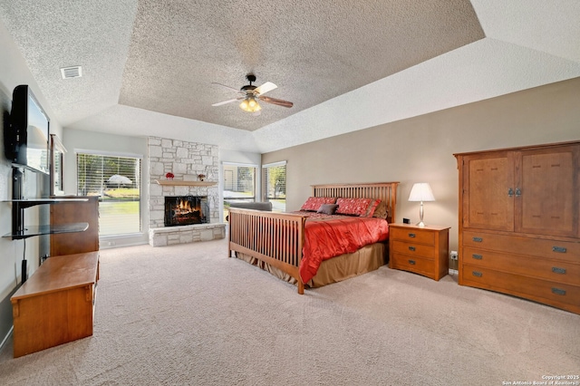 bedroom featuring a tray ceiling, multiple windows, and carpet