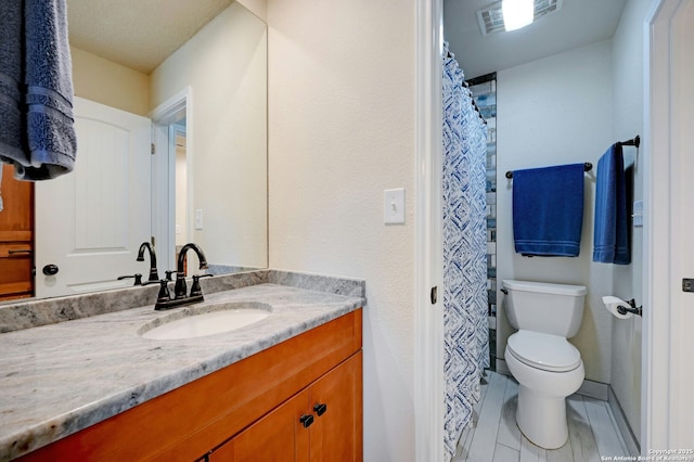 full bath featuring toilet, vanity, and visible vents