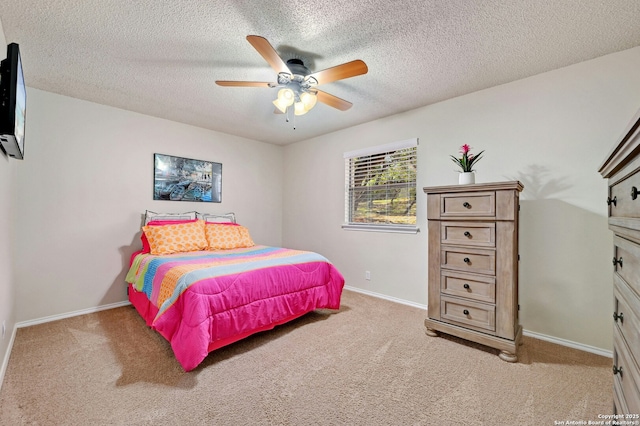 bedroom featuring carpet floors, ceiling fan, baseboards, and a textured ceiling