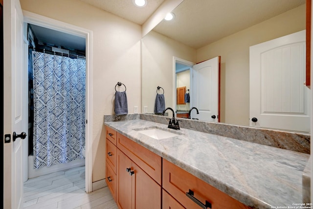 full bathroom with recessed lighting, wood finished floors, and vanity