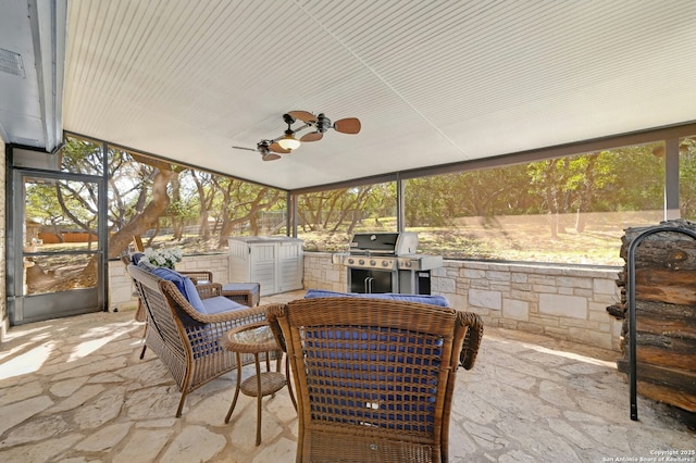 sunroom / solarium featuring ceiling fan and plenty of natural light