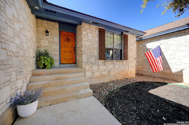 entrance to property with stone siding