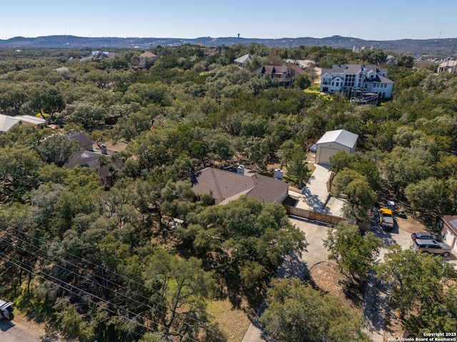 birds eye view of property featuring a mountain view and a forest view