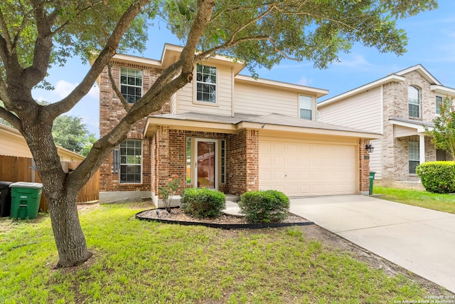 traditional-style house with concrete driveway, an attached garage, fence, a front lawn, and brick siding