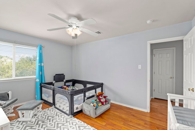 bedroom with visible vents, ceiling fan, light wood-style flooring, and baseboards