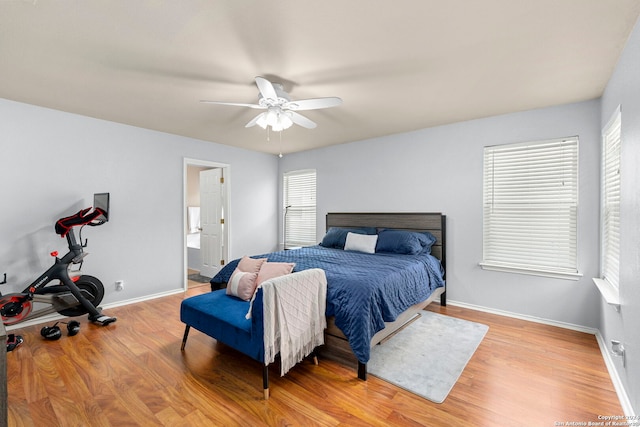 bedroom featuring light wood finished floors, ceiling fan, and baseboards