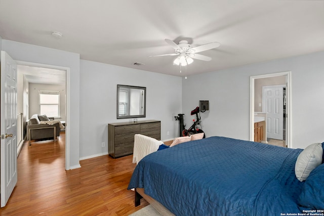 bedroom with light wood finished floors, baseboards, visible vents, and a ceiling fan