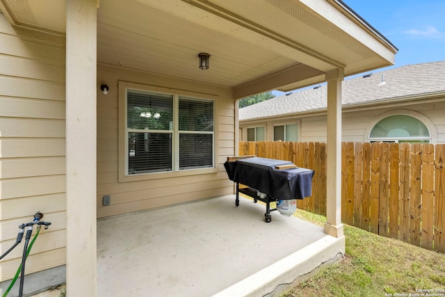 view of patio / terrace featuring fence and a grill