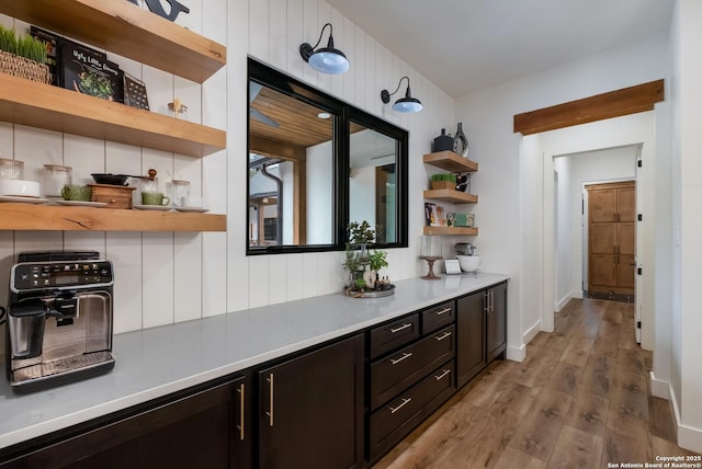 bar with light wood-style flooring and baseboards