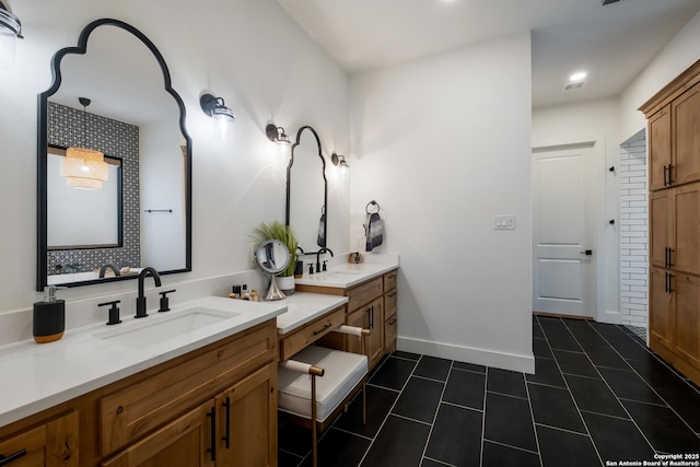 full bath featuring double vanity, tile patterned flooring, a sink, and baseboards