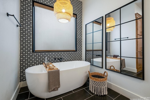 full bath with a soaking tub, tile patterned flooring, baseboards, and tile walls