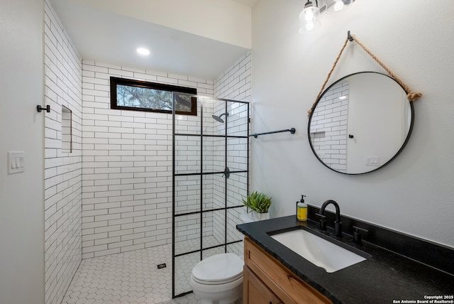 bathroom featuring vanity, toilet, and walk in shower