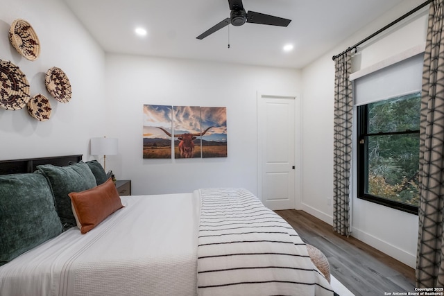 bedroom featuring multiple windows, recessed lighting, wood finished floors, and baseboards