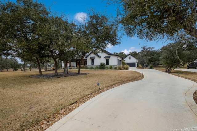 view of front of home with a front lawn and concrete driveway