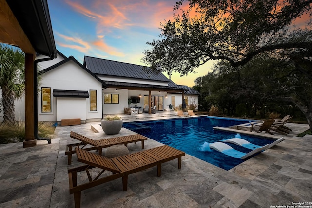 outdoor pool with a patio and an outdoor structure