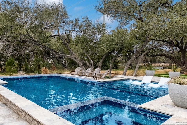 view of pool featuring a pool with connected hot tub