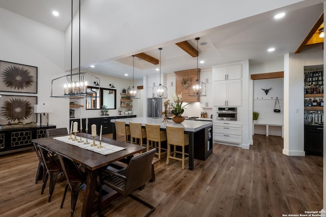 dining area with recessed lighting, dark wood-style flooring, and beam ceiling