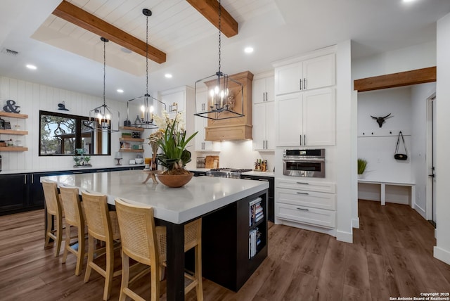 kitchen with open shelves, white cabinets, light countertops, and stainless steel oven