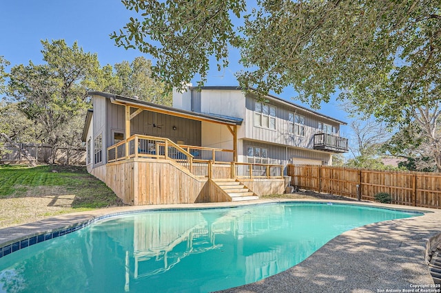 view of pool featuring stairs, a fenced backyard, a ceiling fan, and a fenced in pool