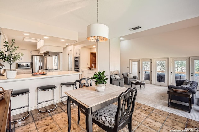 dining area featuring light colored carpet, recessed lighting, and visible vents