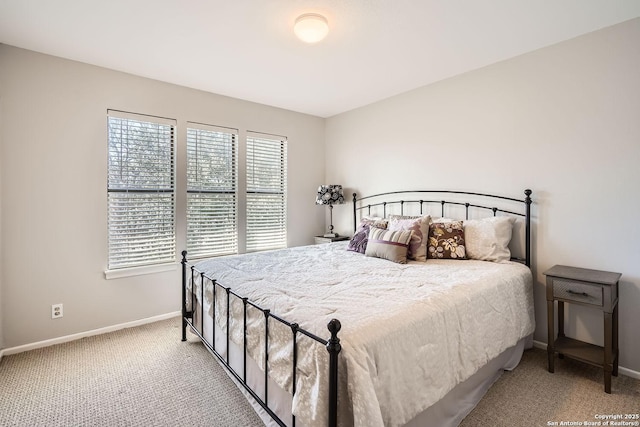 bedroom with light colored carpet and baseboards