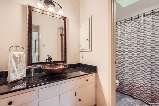 full bath featuring toilet, a shower with shower curtain, and vanity