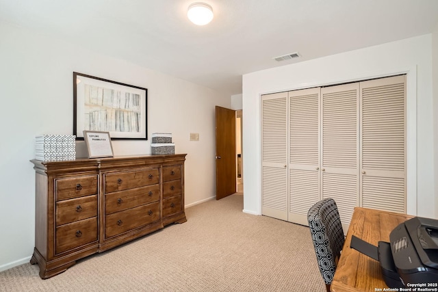 office space with light colored carpet, visible vents, and baseboards