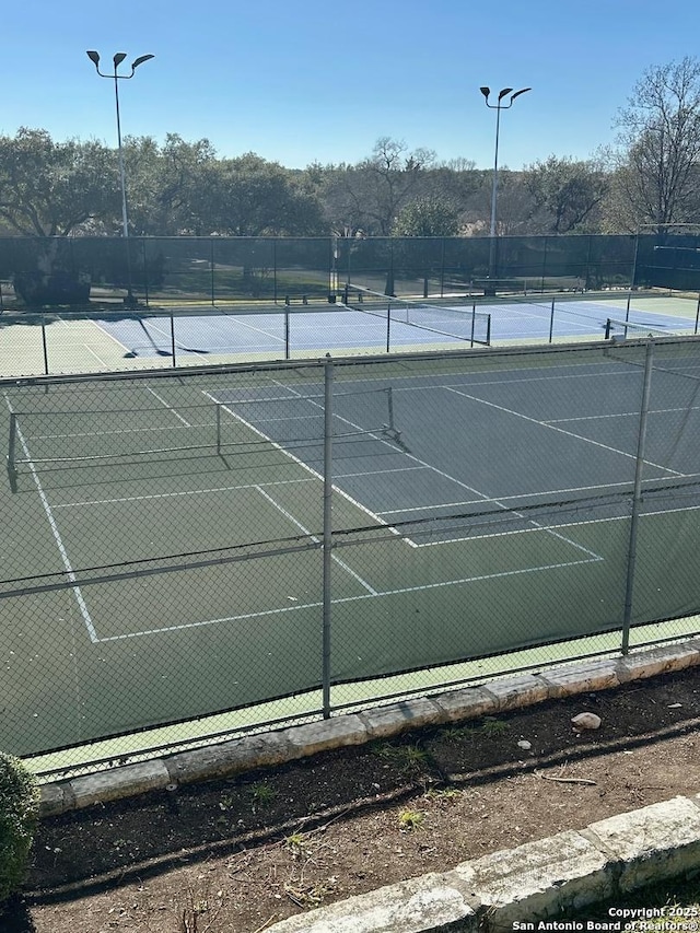 view of sport court featuring fence