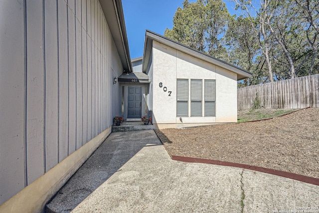 view of exterior entry with fence