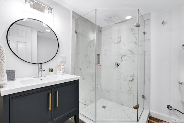 full bathroom with a stall shower, vanity, and baseboards