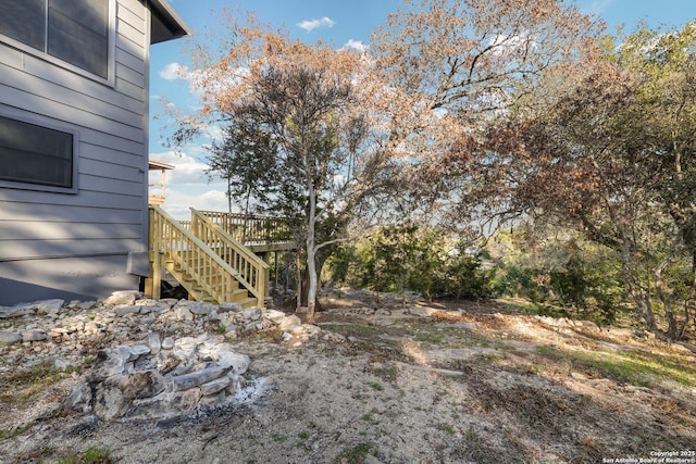 view of yard with stairway and a wooden deck