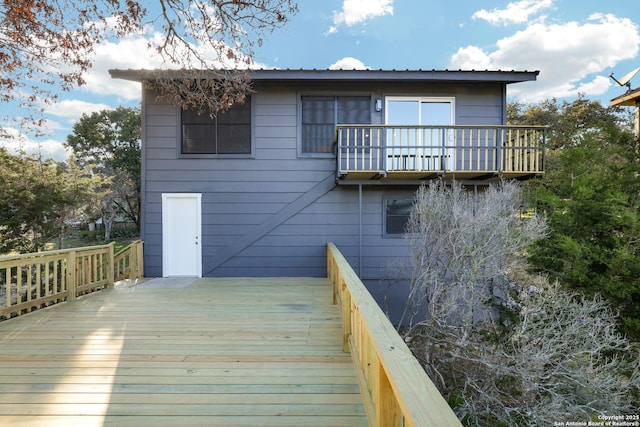 rear view of house with a wooden deck