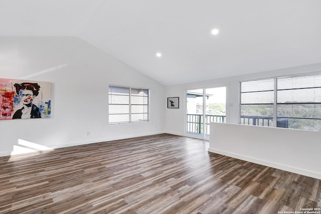 empty room featuring high vaulted ceiling, recessed lighting, baseboards, and wood finished floors