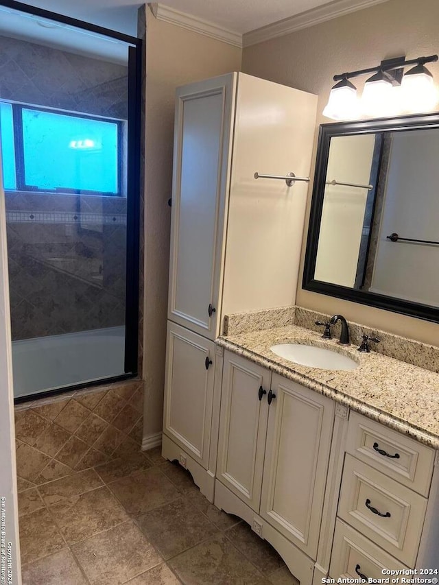 bathroom with a shower, crown molding, and vanity