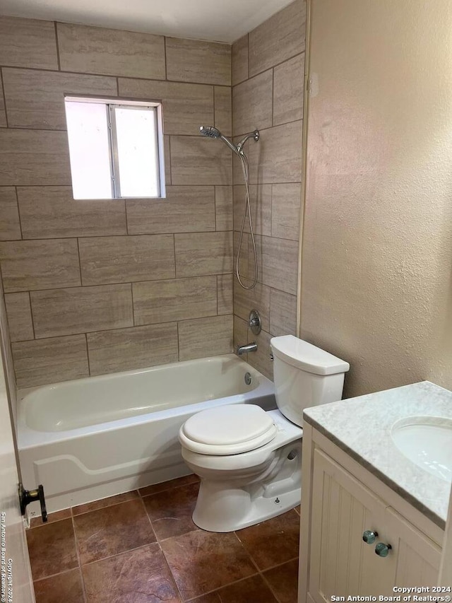 bathroom featuring toilet, a textured wall, shower / tub combination, and vanity