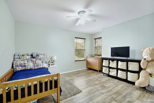 bedroom featuring ceiling fan, wood finished floors, and baseboards