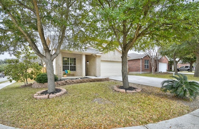 view of front of property featuring a front yard, brick siding, driveway, and an attached garage