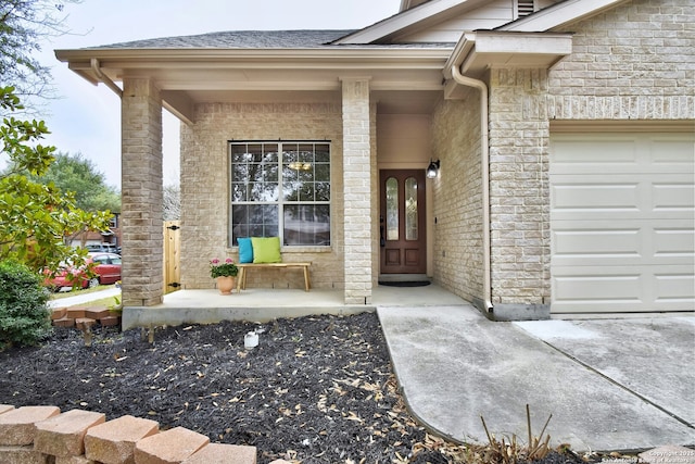 property entrance featuring a garage, covered porch, and a shingled roof