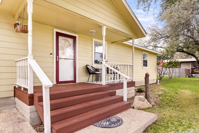 view of exterior entry with a yard