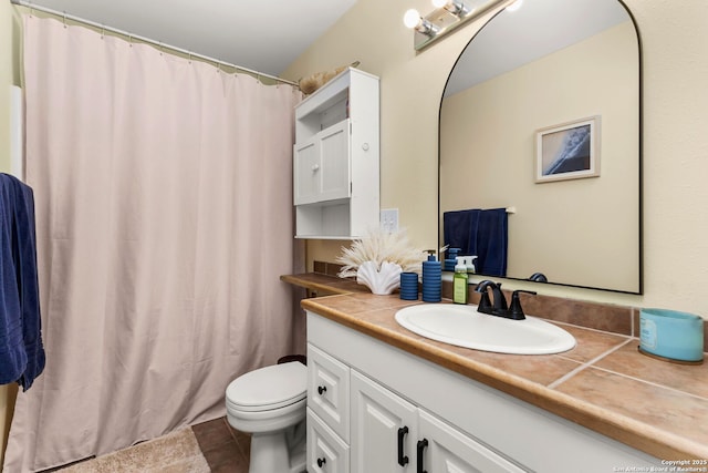 bathroom with vanity, toilet, and tile patterned floors