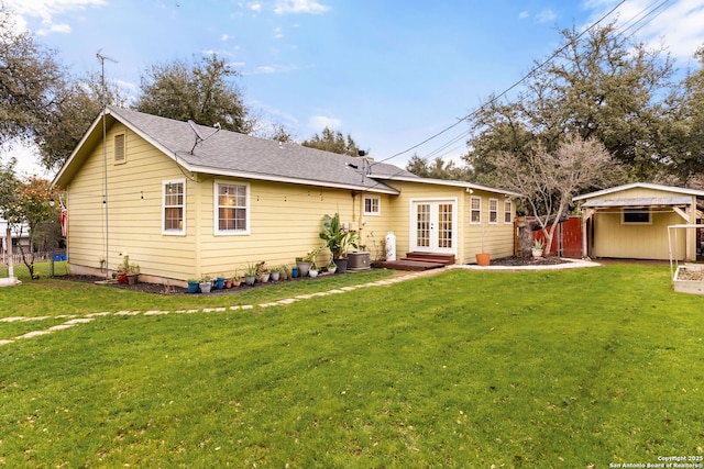 back of house featuring a yard, roof with shingles, fence, and french doors