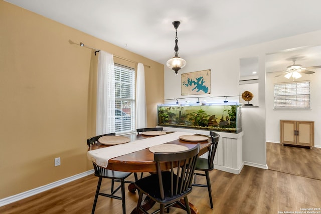 dining area featuring ceiling fan, wood finished floors, and baseboards