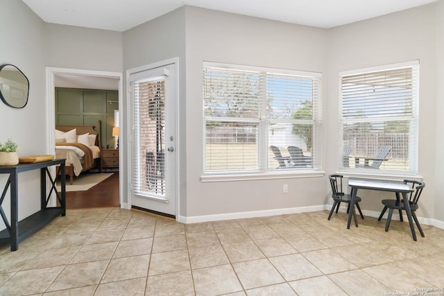 interior space with light tile patterned floors and baseboards