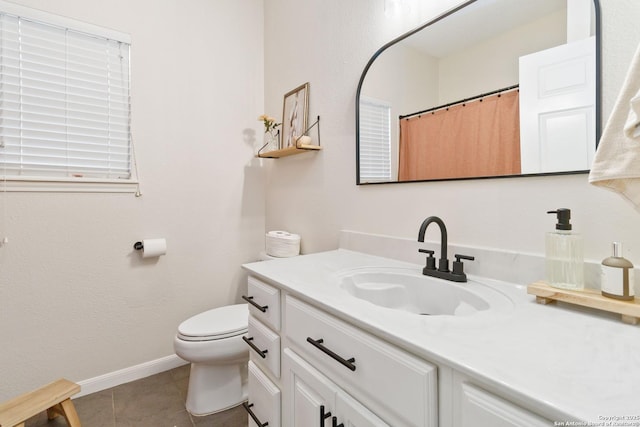 full bathroom featuring toilet, vanity, baseboards, and tile patterned floors