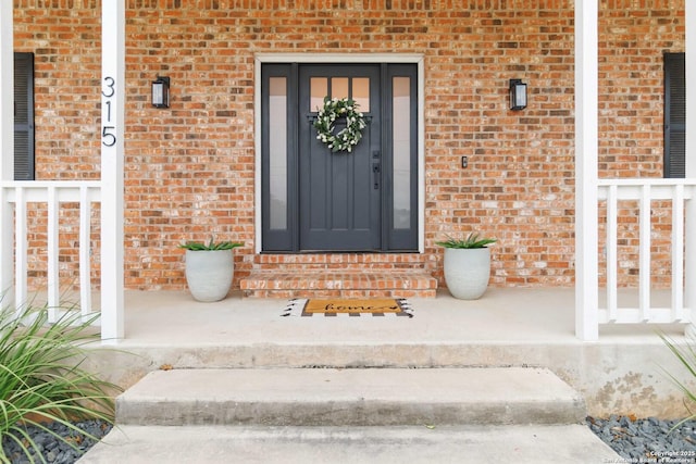 property entrance with brick siding